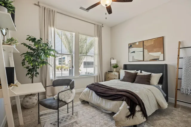 a bedroom with a bed and a table in it