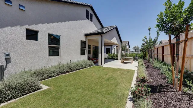 a view of a house with backyard and porch