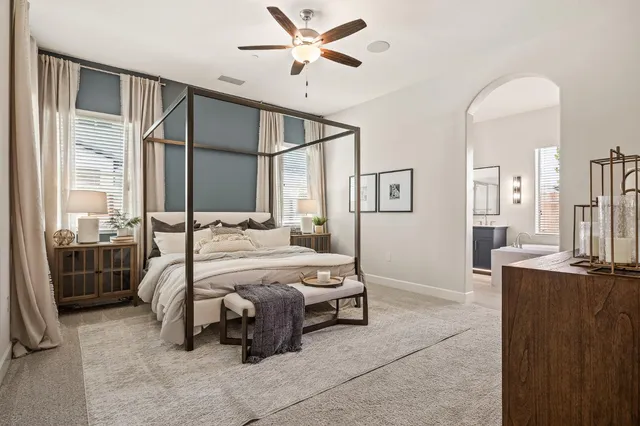 a bedroom with a bed and a chandelier