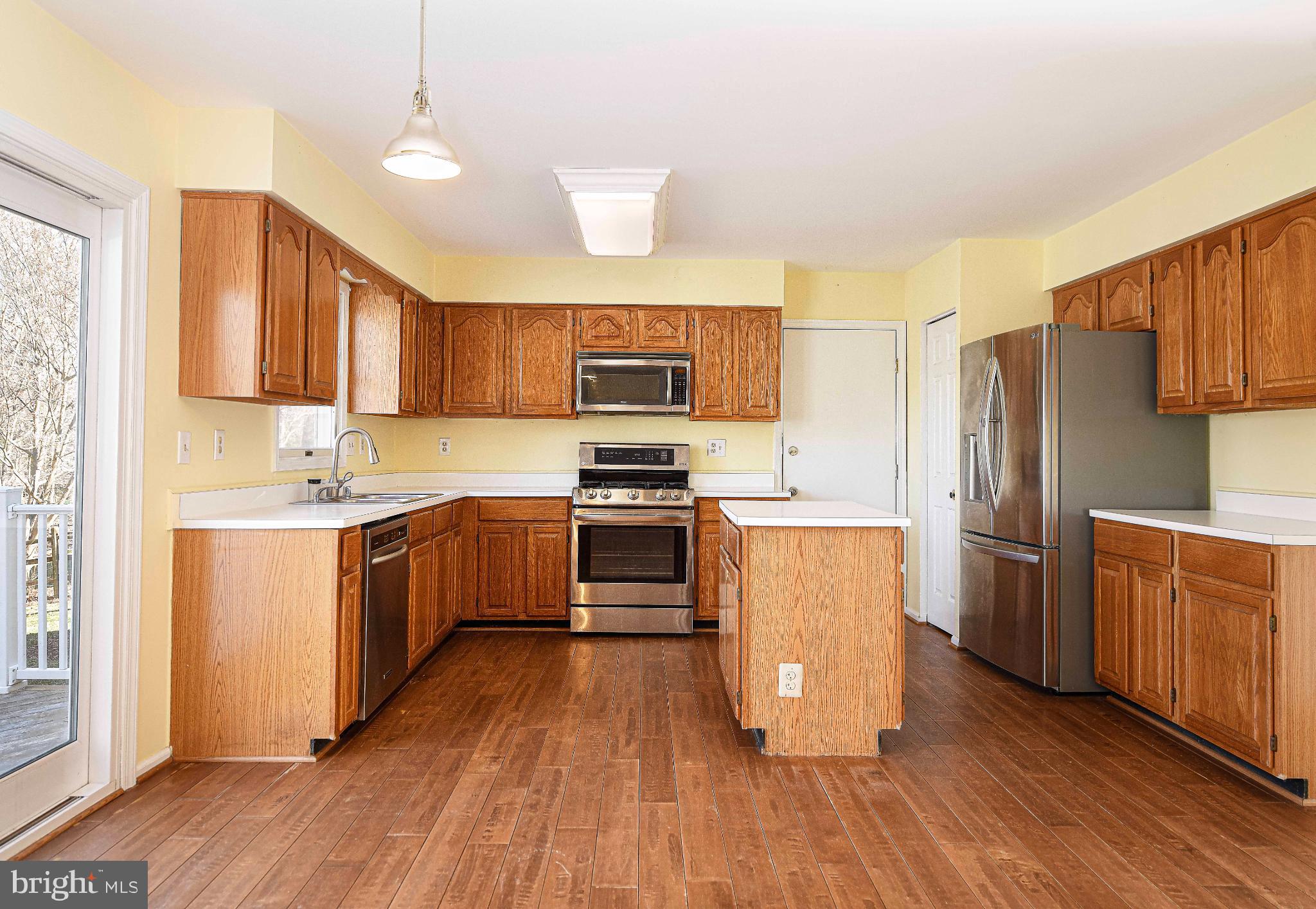 644 Symphony Woods Drive Silver Spring, MD 20901 - Photo 23 of 53 a kitchen with wooden floors appliances and wooden cabinets