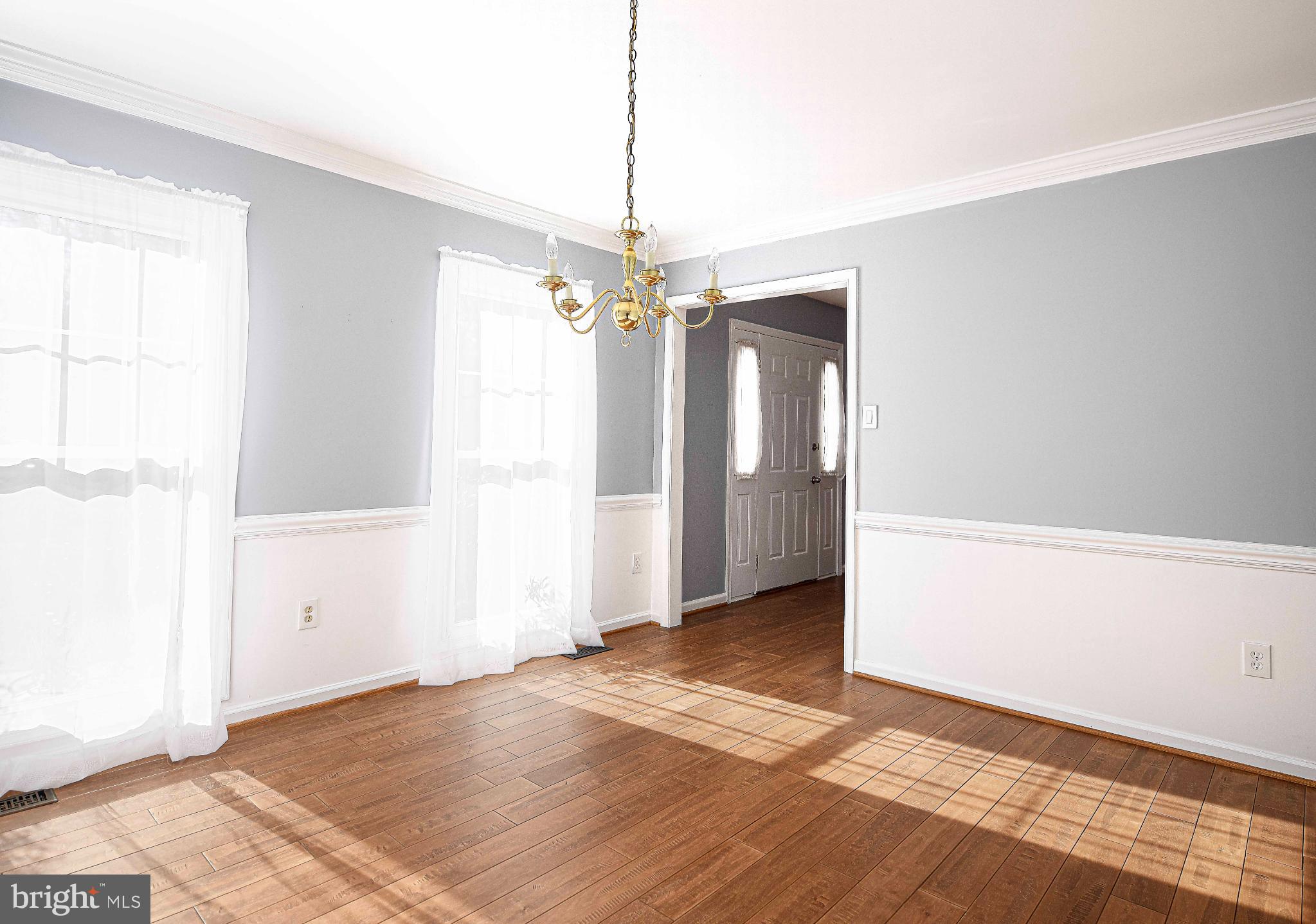 644 Symphony Woods Drive Silver Spring, MD 20901 - Photo 25 of 53 a view of a livingroom with a chandelier fan and windows