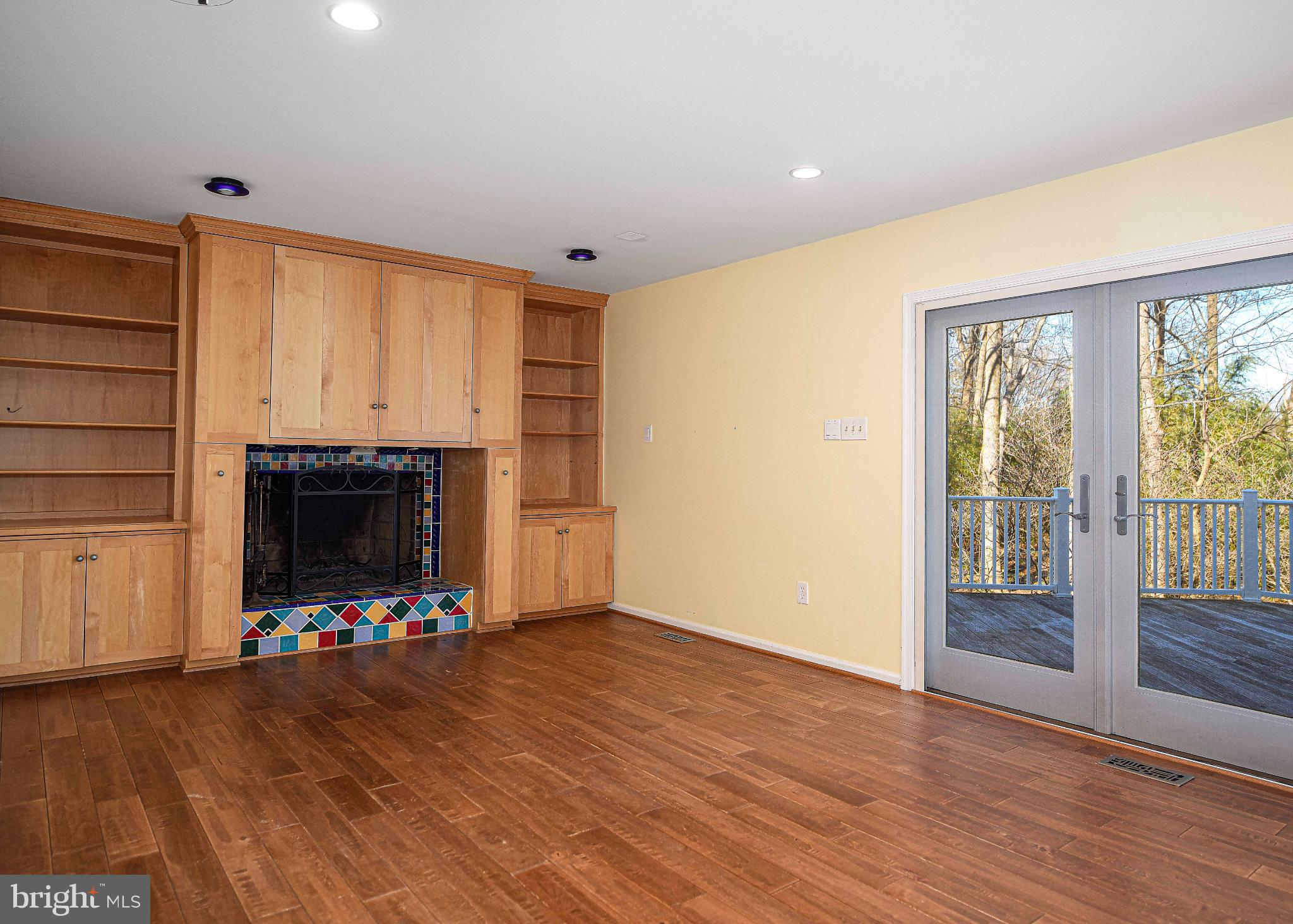 644 Symphony Woods Drive Silver Spring, MD 20901 - Photo 27 of 53 a view of an empty room with wooden floor a fireplace and a window