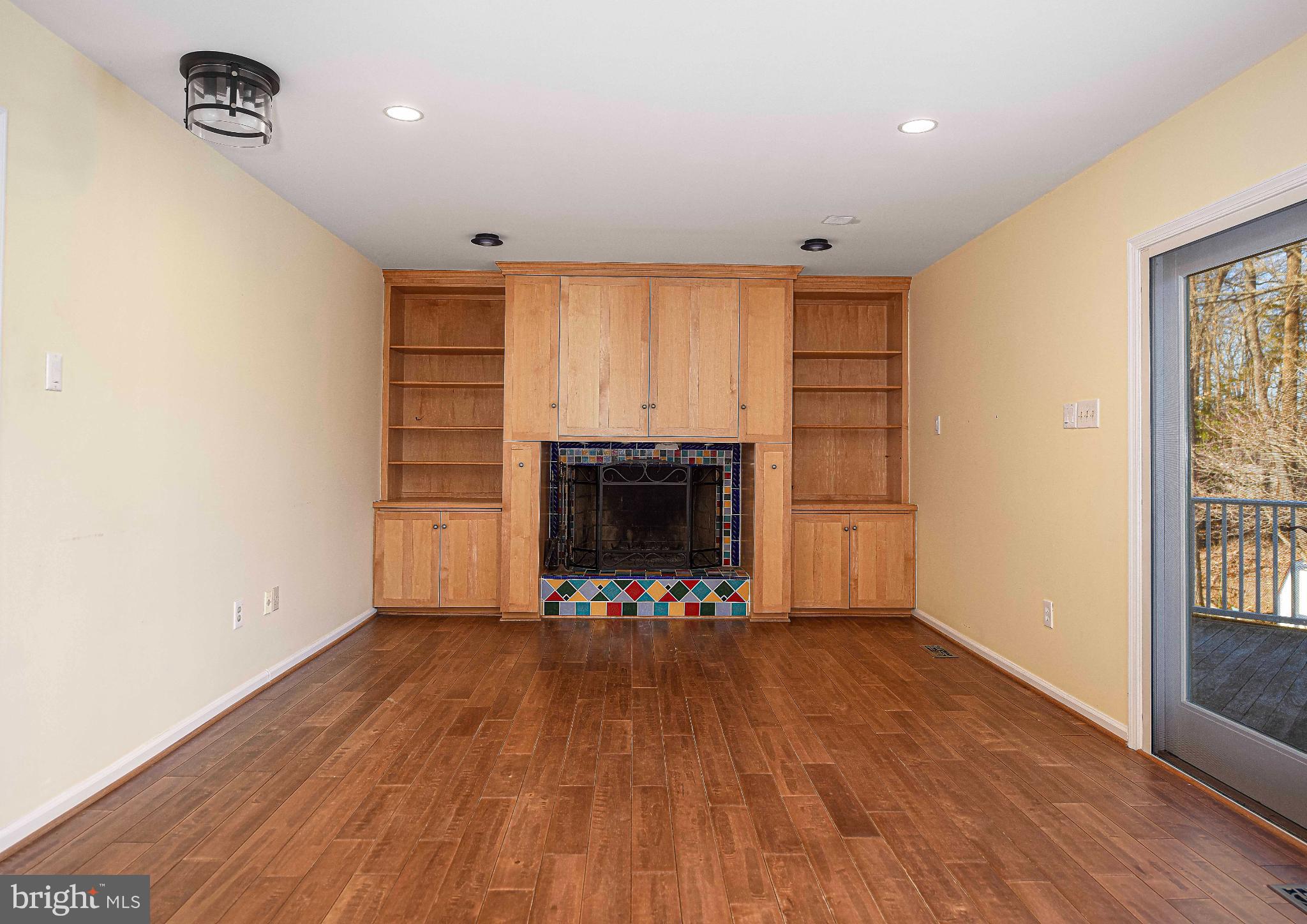 644 Symphony Woods Drive Silver Spring, MD 20901 - Photo 28 of 53 wooden floor in an empty room with a fireplace and a window