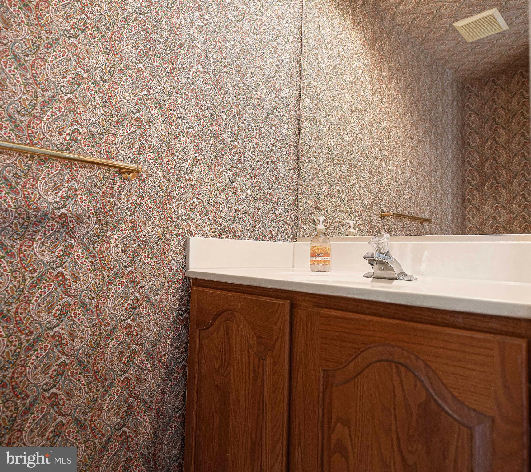 644 Symphony Woods Drive Silver Spring, MD 20901 - Photo 29 of 53 a bathroom with a sink and a mirror