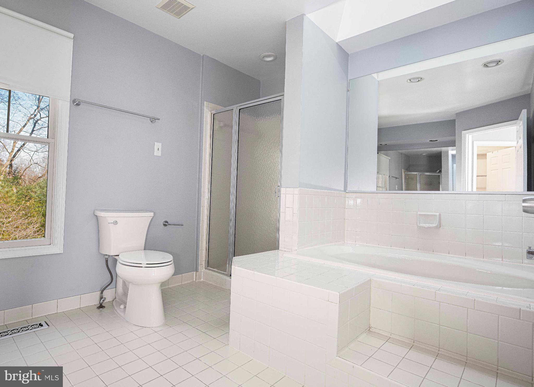 644 Symphony Woods Drive Silver Spring, MD 20901 - Photo 35 of 53 a bathroom with a toilet sink and mirror