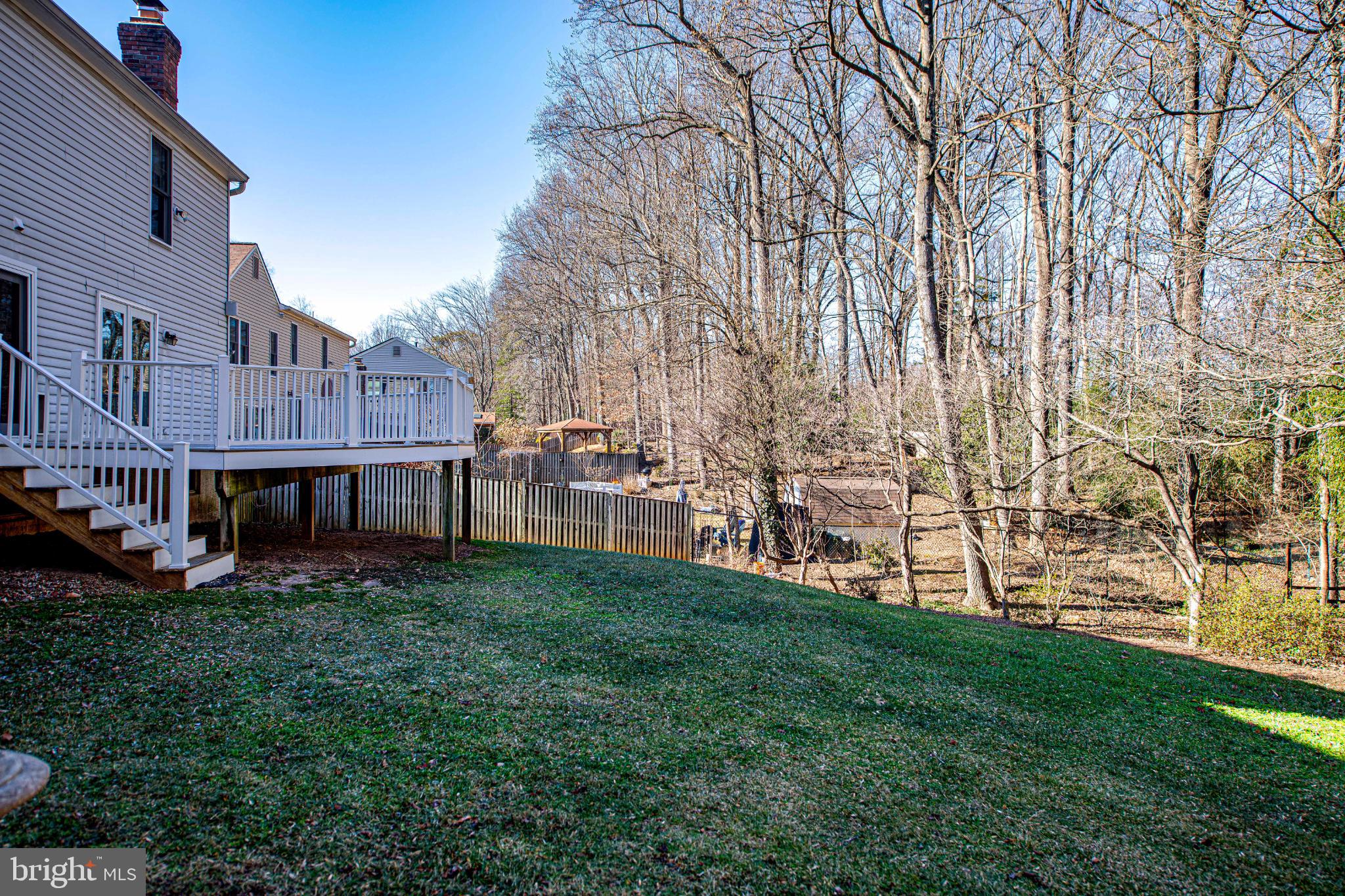 644 Symphony Woods Drive Silver Spring, MD 20901 - Photo 8 of 53 a view of backyard with large trees and a barn