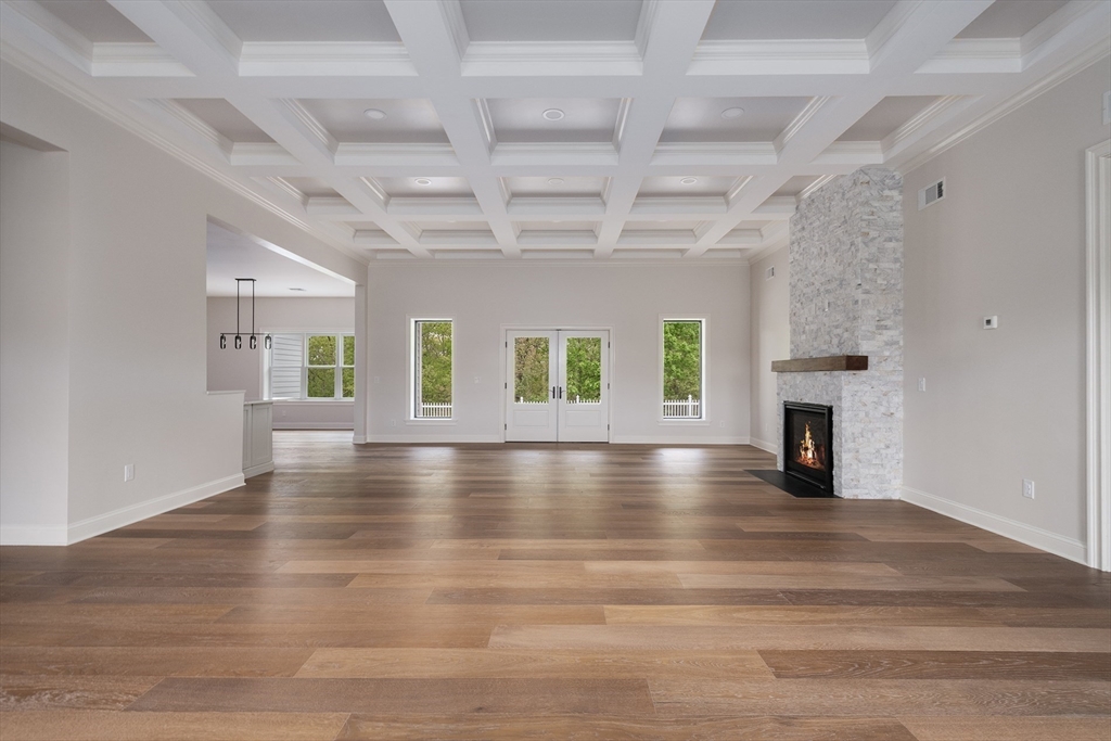 68 Richard Circle Seekonk, MA 02771 - Photo 11 of 40 an empty room with wooden floor fireplace and windows