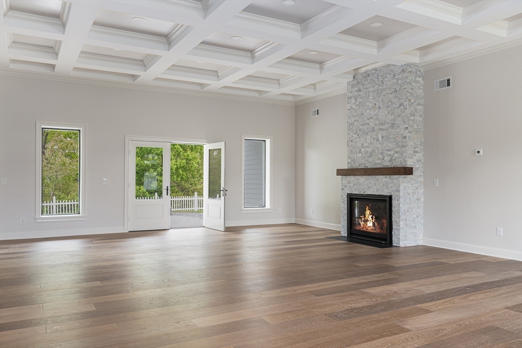 68 Richard Circle Seekonk, MA 02771 - Photo 12 of 40 an empty room with wooden floor fireplace and windows