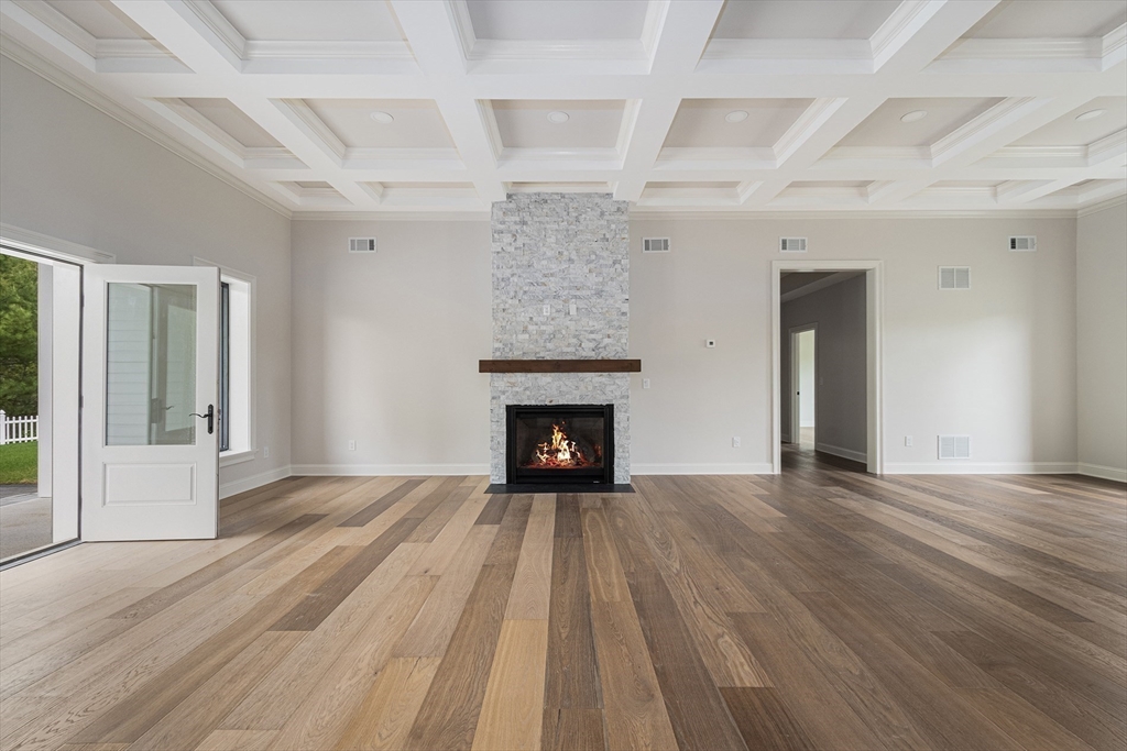 68 Richard Circle Seekonk, MA 02771 - Photo 13 of 40 a view of an empty room with wooden floor fireplace and a window