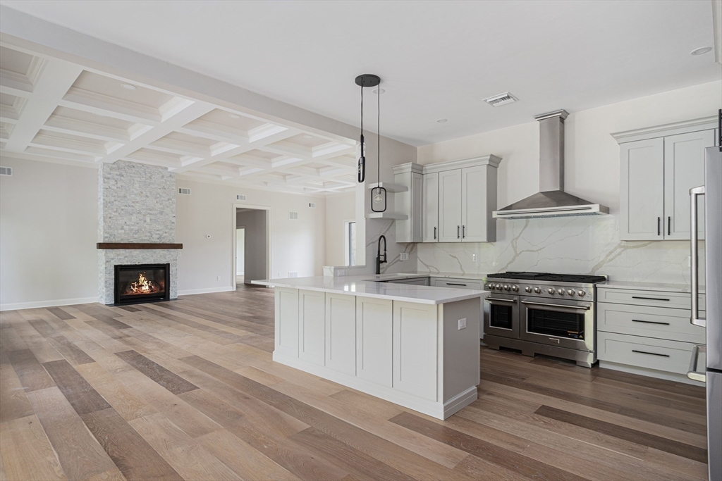 68 Richard Circle Seekonk, MA 02771 - Photo 21 of 40 a kitchen with stainless steel appliances granite countertop a stove oven and a fireplace