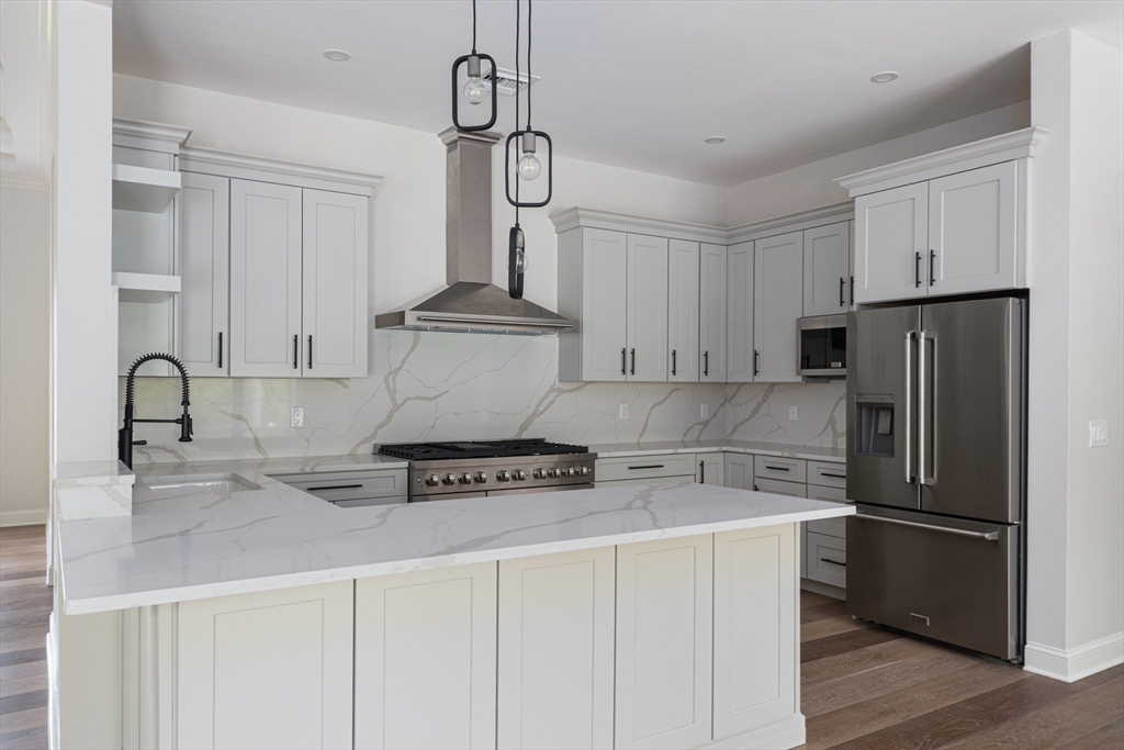 68 Richard Circle Seekonk, MA 02771 - Photo 22 of 40 a kitchen with stainless steel appliances granite countertop a sink a stove a refrigerator and cabinets