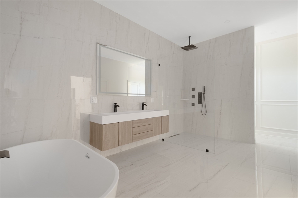 68 Richard Circle Seekonk, MA 02771 - Photo 29 of 40 a bathroom with a sink a mirror and a bathtub