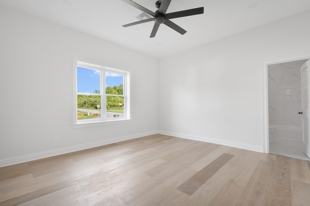 68 Richard Circle Seekonk, MA 02771 - Photo 30 of 40 an empty room with a window and a ceiling fan