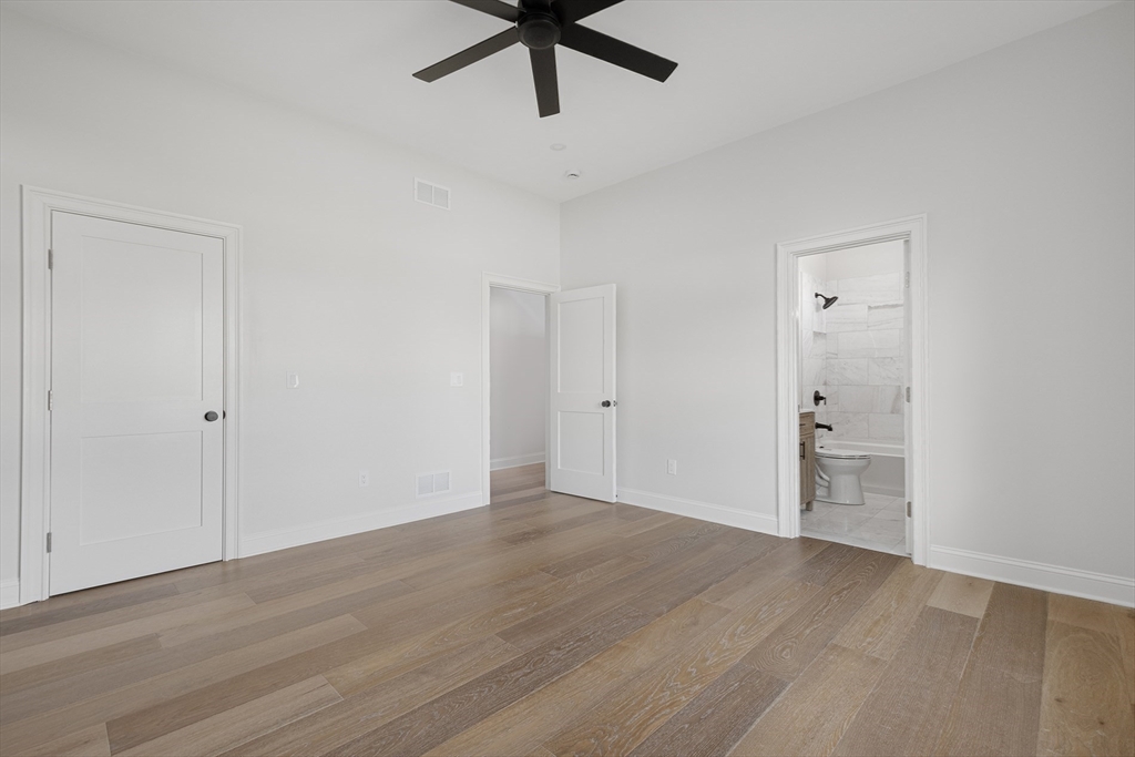 68 Richard Circle Seekonk, MA 02771 - Photo 32 of 40 a view of an empty room with wooden floor and a ceiling fan