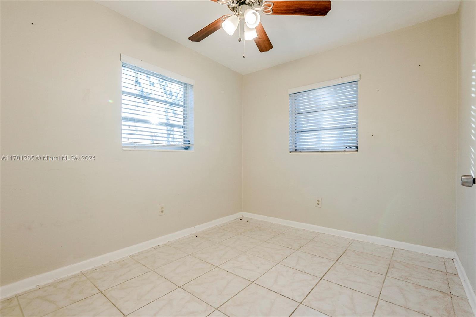 14281 Southwest 285th Street Homestead, FL 33033 - Photo 16 of 27 an empty room with chandelier fan
