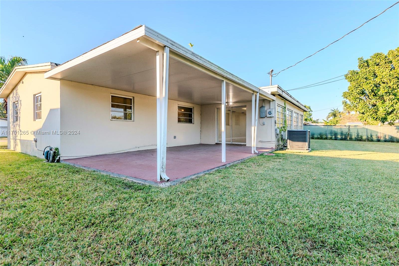 14281 Southwest 285th Street Homestead, FL 33033 - Photo 26 of 27 a front view of a house with a yard and garage