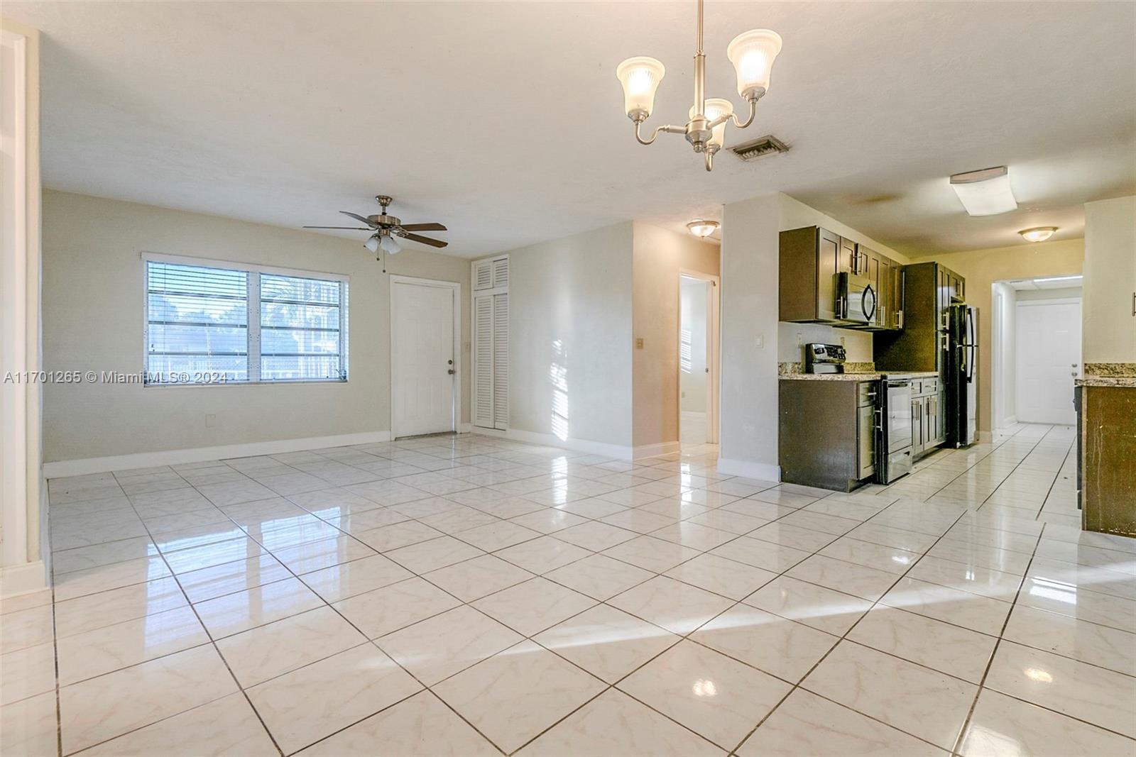 14281 Southwest 285th Street Homestead, FL 33033 - Photo 3 of 27 a view of a kitchen with furniture and a chandelier