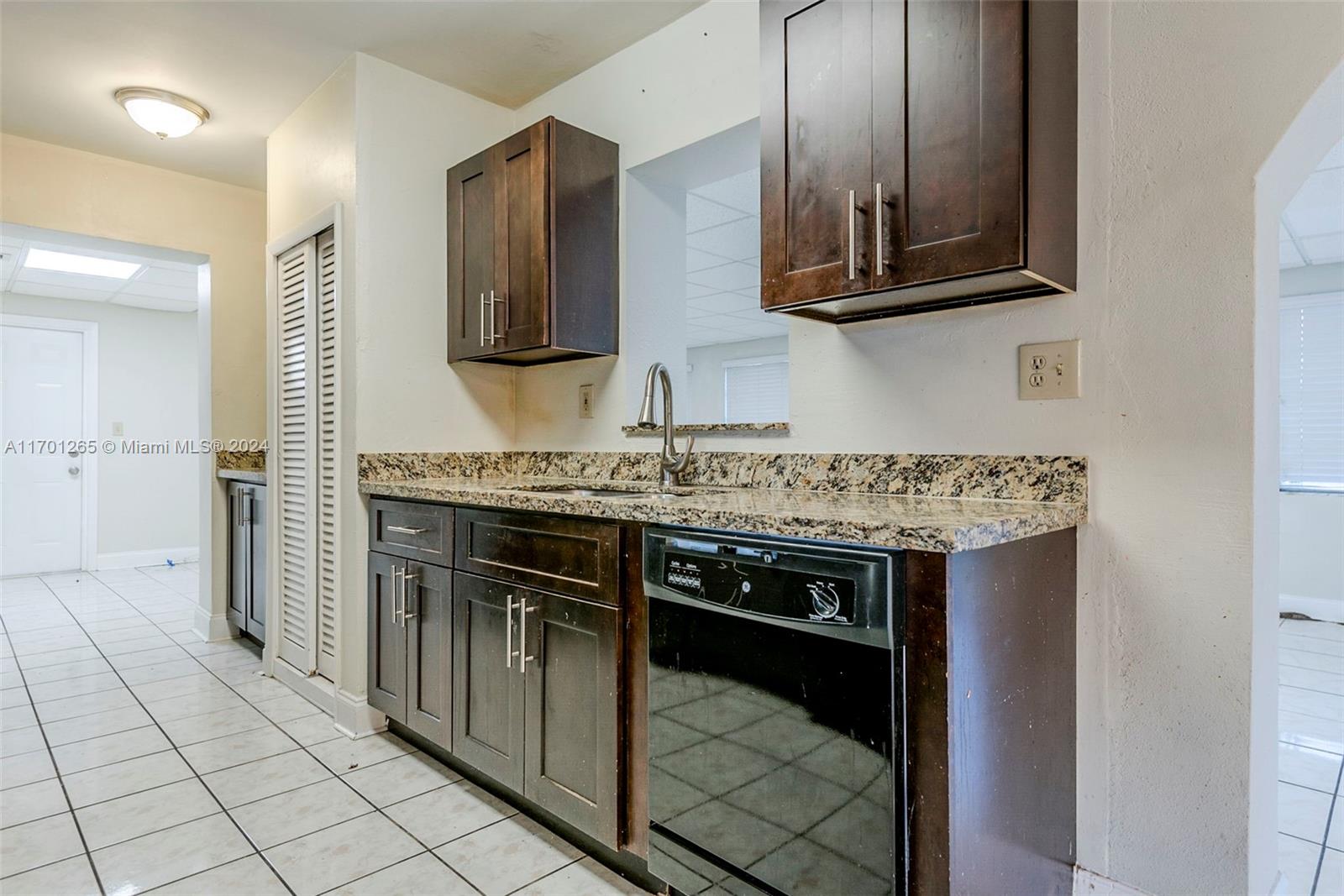14281 Southwest 285th Street Homestead, FL 33033 - Photo 8 of 27 a kitchen with stainless steel appliances granite countertop a stove and a microwave