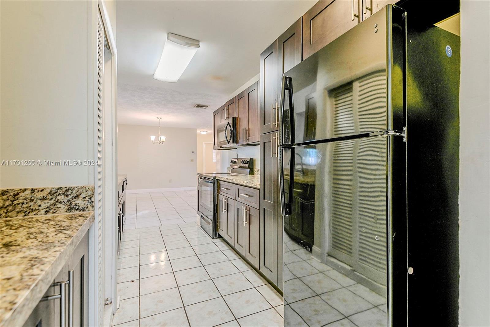 14281 Southwest 285th Street Homestead, FL 33033 - Photo 9 of 27 a kitchen with stainless steel appliances granite countertop a refrigerator and a stove