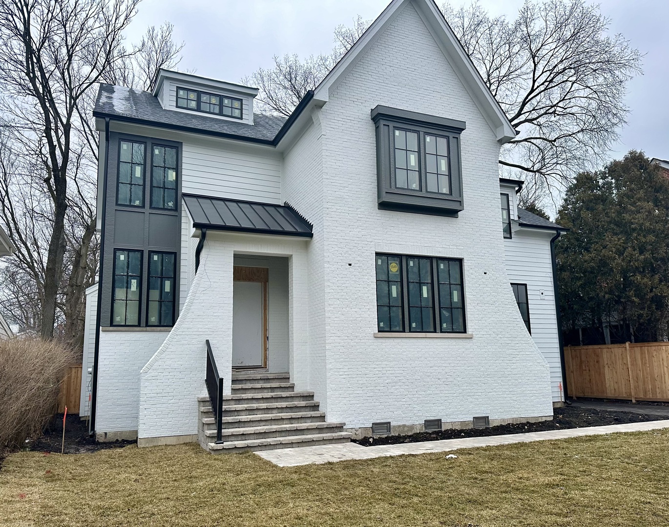 1155 Ash Street Winnetka, IL 60093 - Photo 4 of 13 a front view of a house with stairs