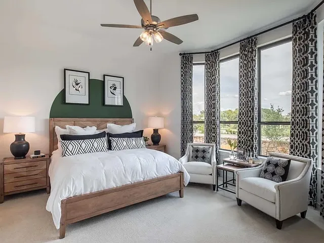 a bedroom with a bed couch and window