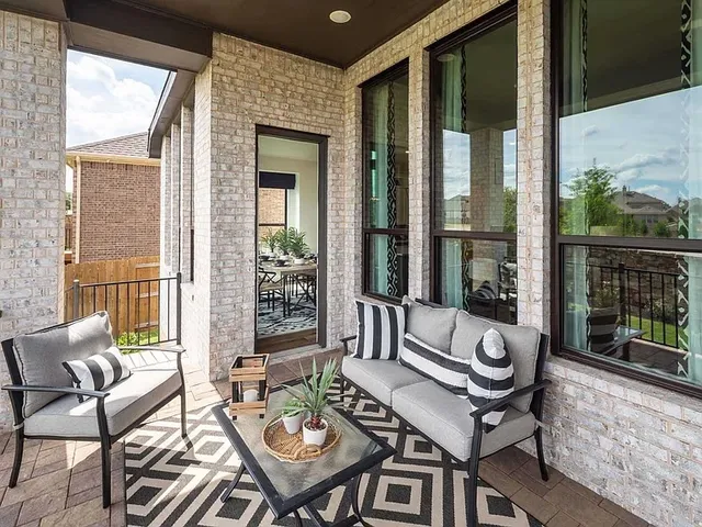 a balcony with furniture and glass door
