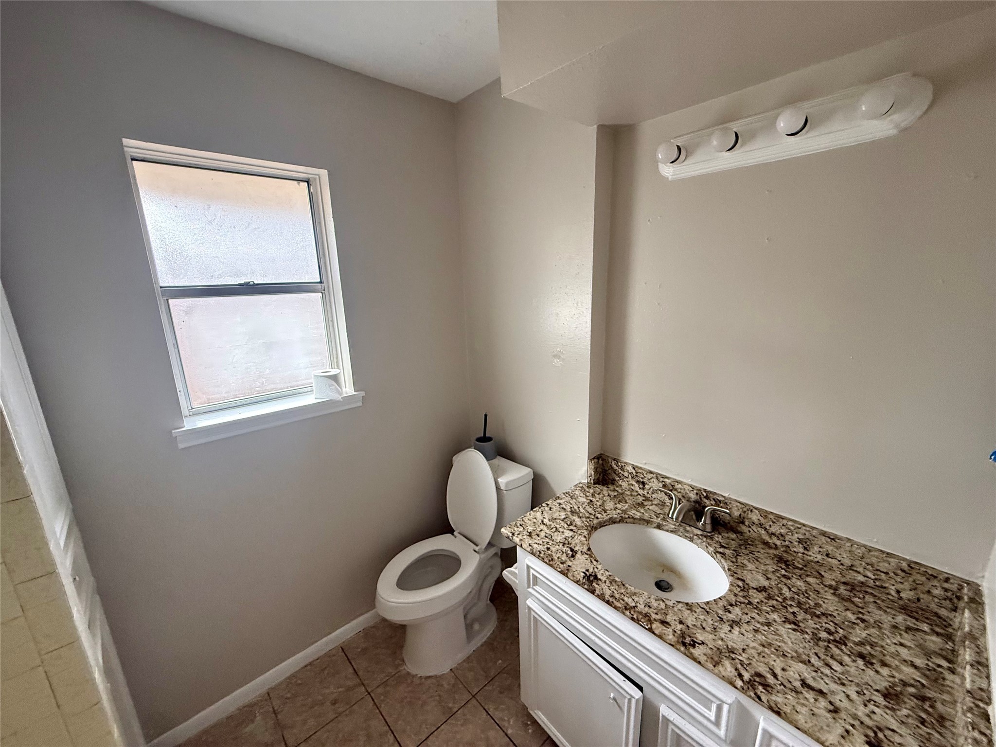 3211 Hartfield Lane Spring, TX 77388 - Photo 13 of 23 a bathroom with a granite countertop sink and a toilet