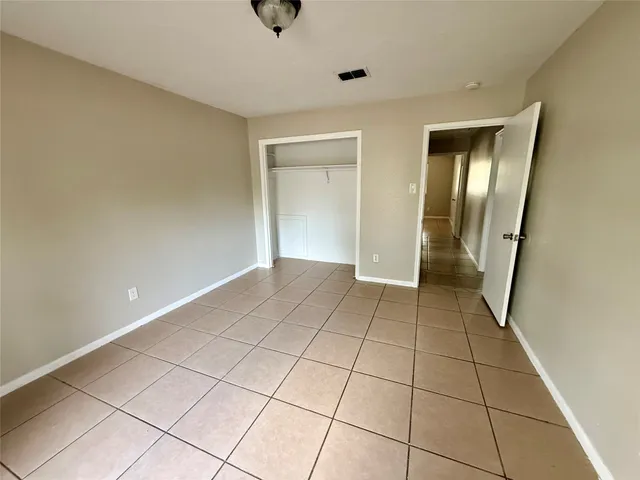 a view of a livingroom with an empty space and a window