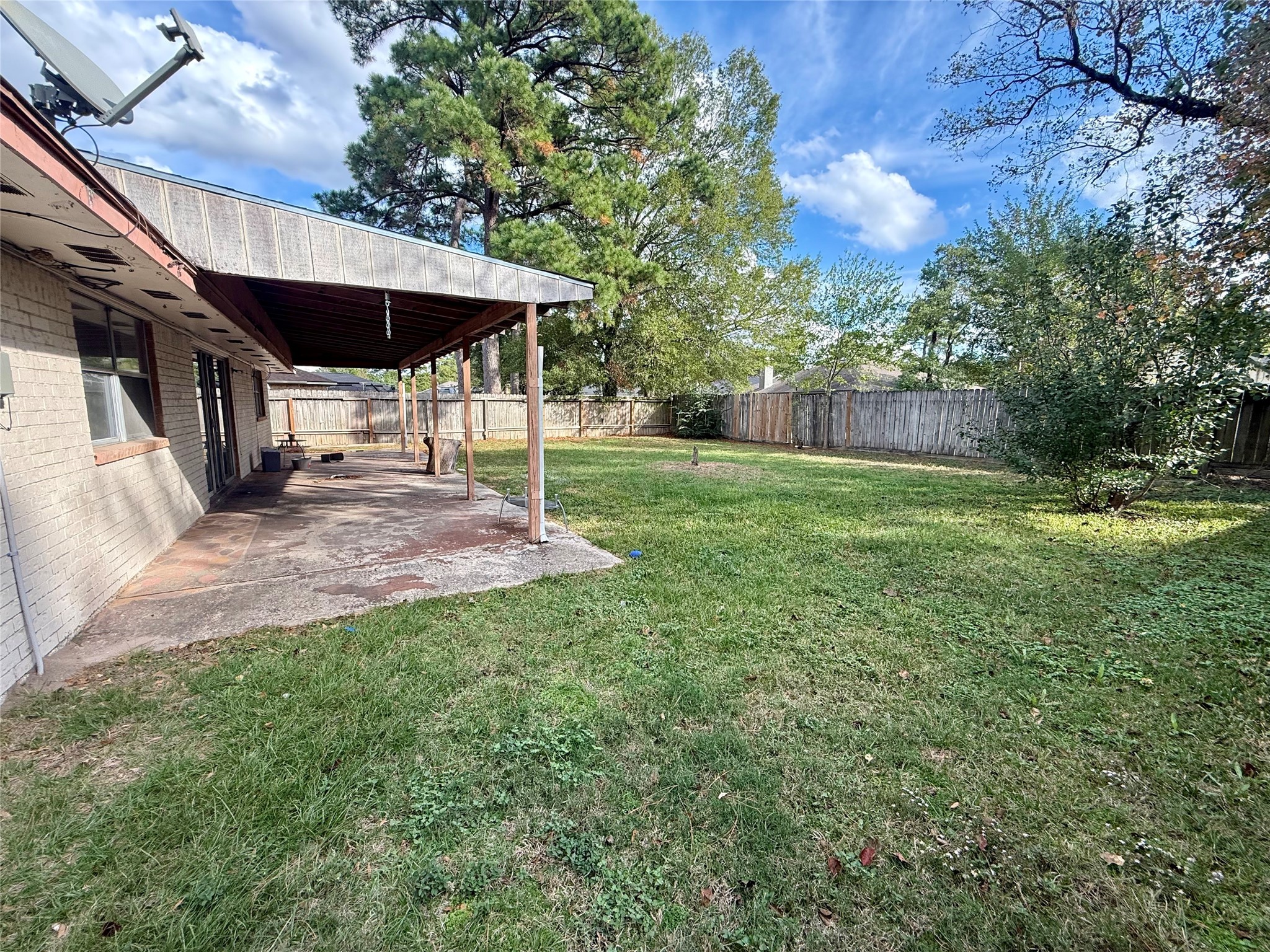 3211 Hartfield Lane Spring, TX 77388 - Photo 20 of 23 a view of a patio with a table and chairs under an umbrella