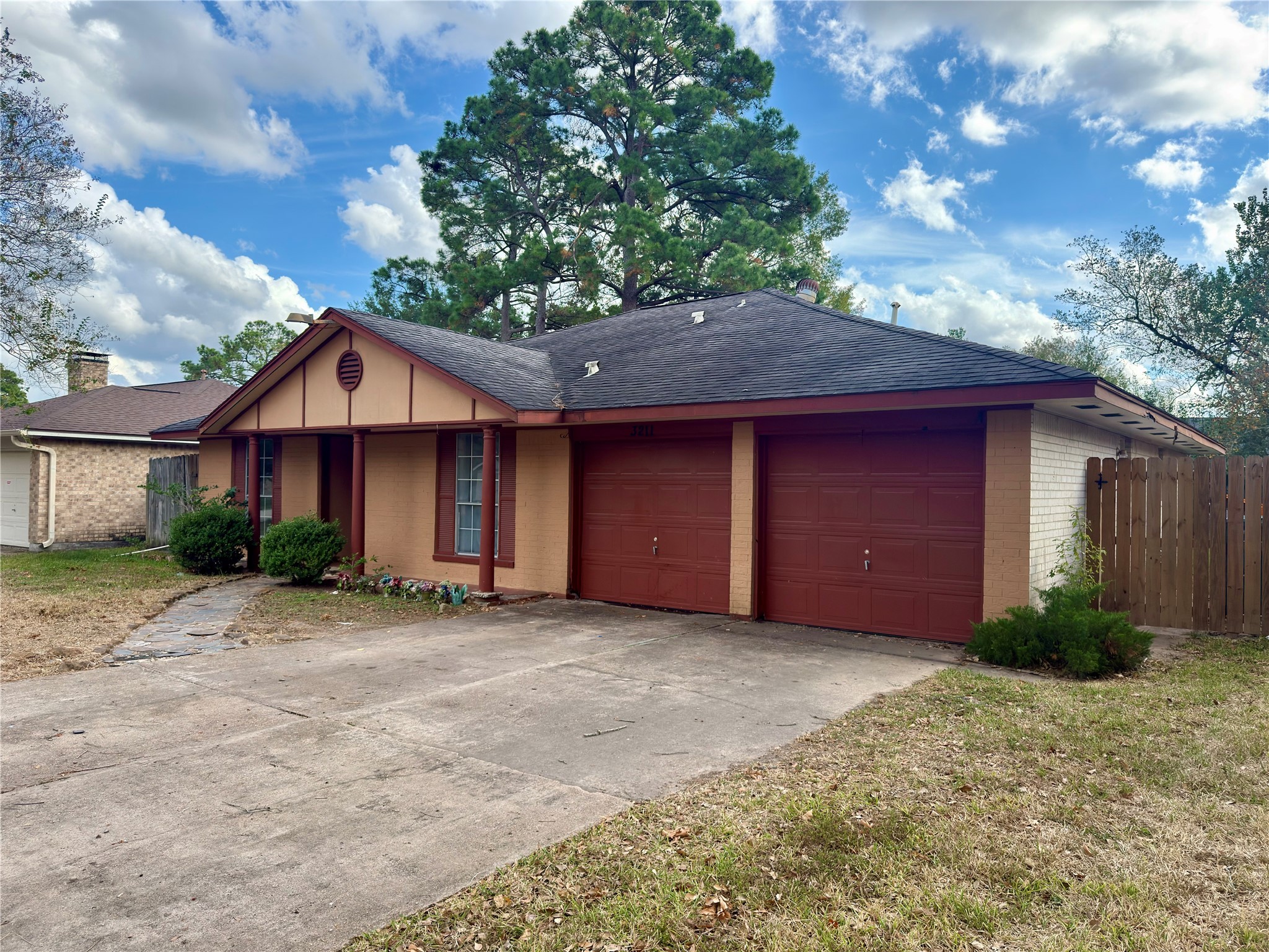3211 Hartfield Lane Spring, TX 77388 - Photo 4 of 23 a front view of a house with a garden