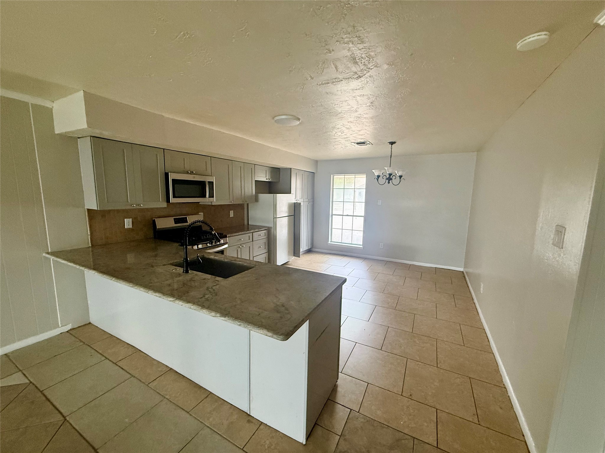 3211 Hartfield Lane Spring, TX 77388 - Photo 6 of 23 a kitchen with a sink a microwave and cabinets