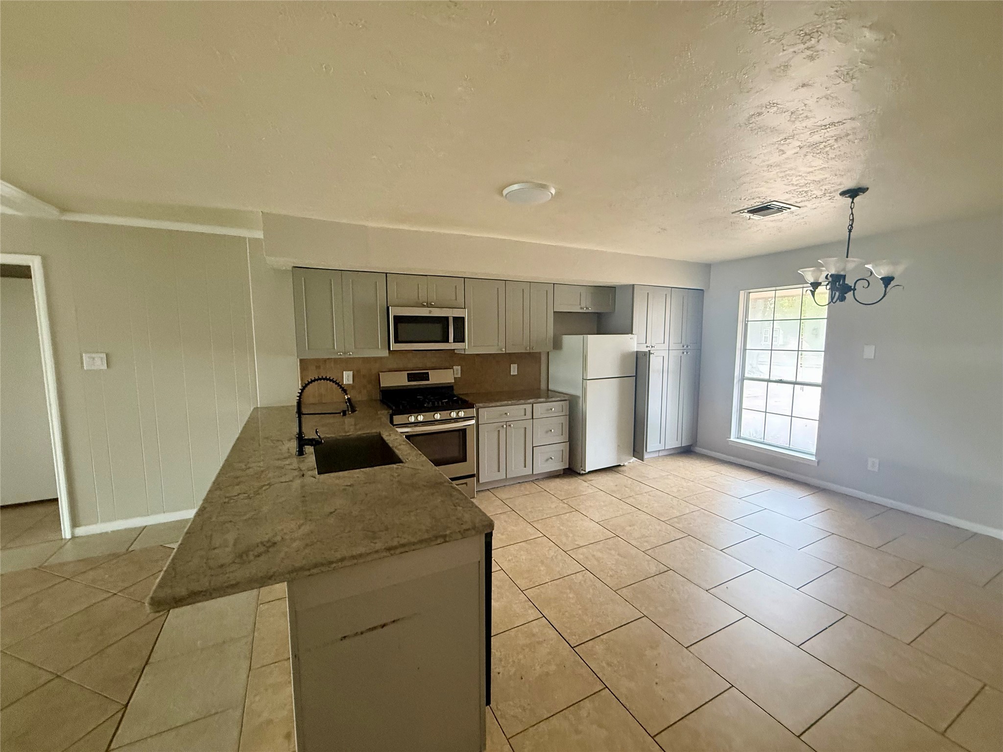 3211 Hartfield Lane Spring, TX 77388 - Photo 7 of 23 a kitchen with stainless steel appliances a refrigerator sink and stove