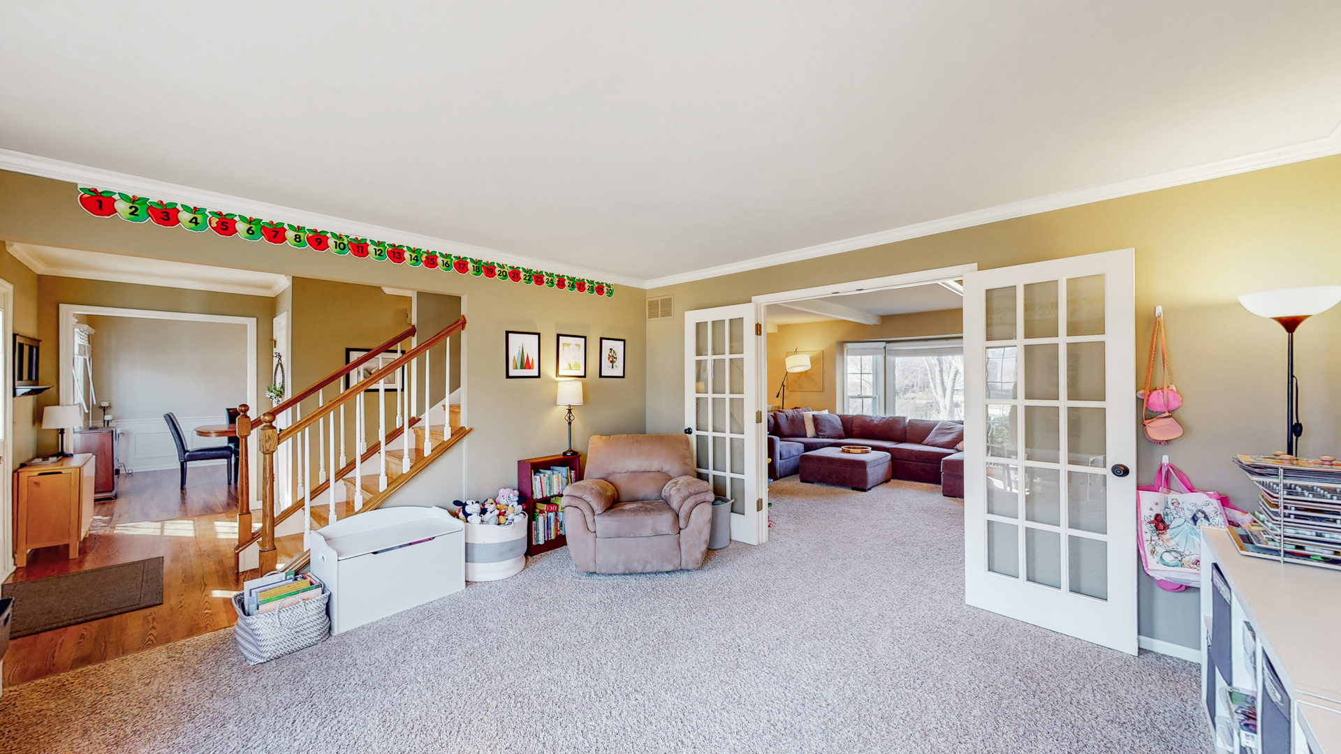 821 South River Road Naperville, IL 60540 - Photo 11 of 32 a living room with lots of furniture and a book shelf