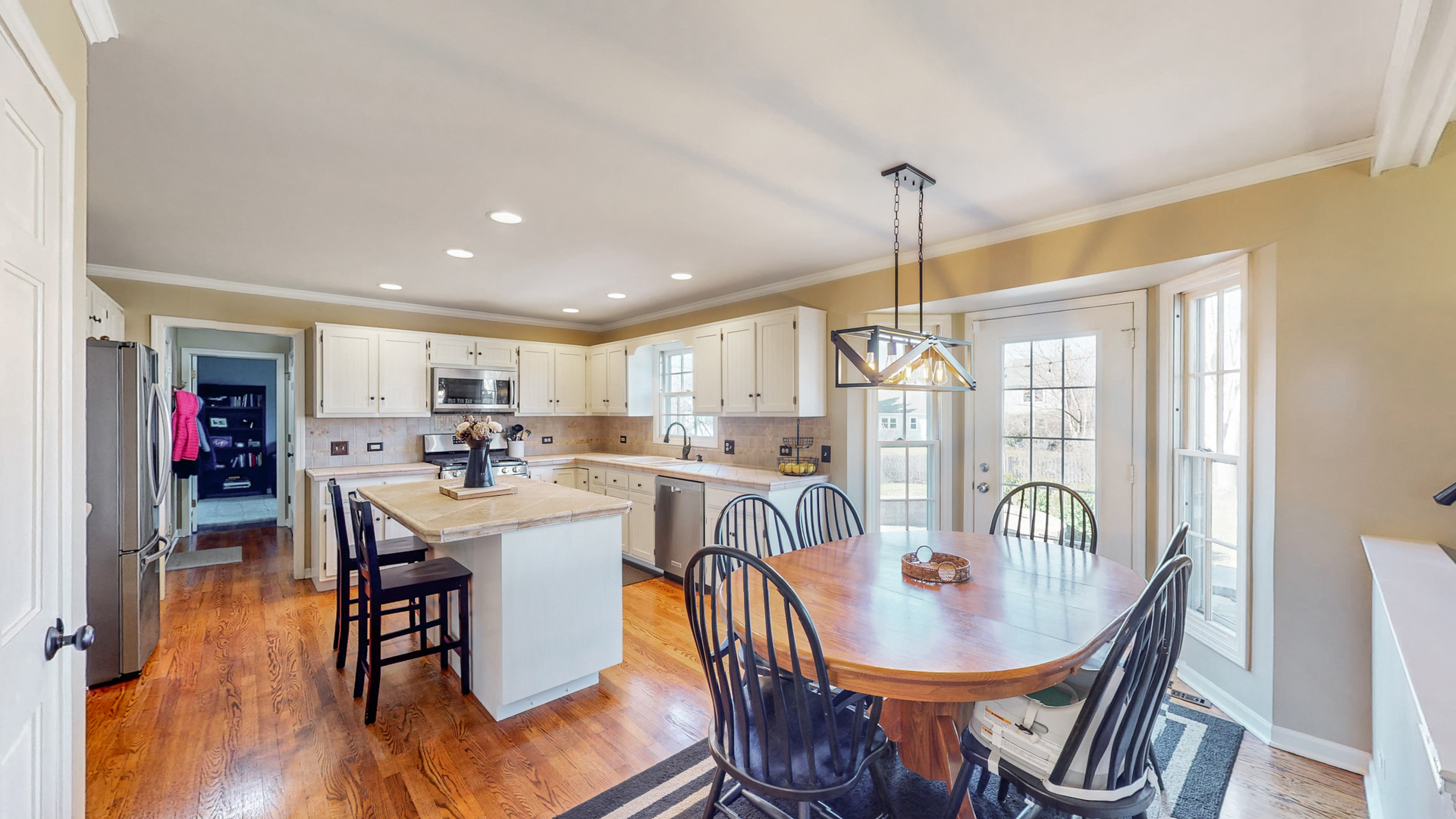 821 South River Road Naperville, IL 60540 - Photo 6 of 32 a view of a dining room and livingroom with furniture wooden floor a chandelier
