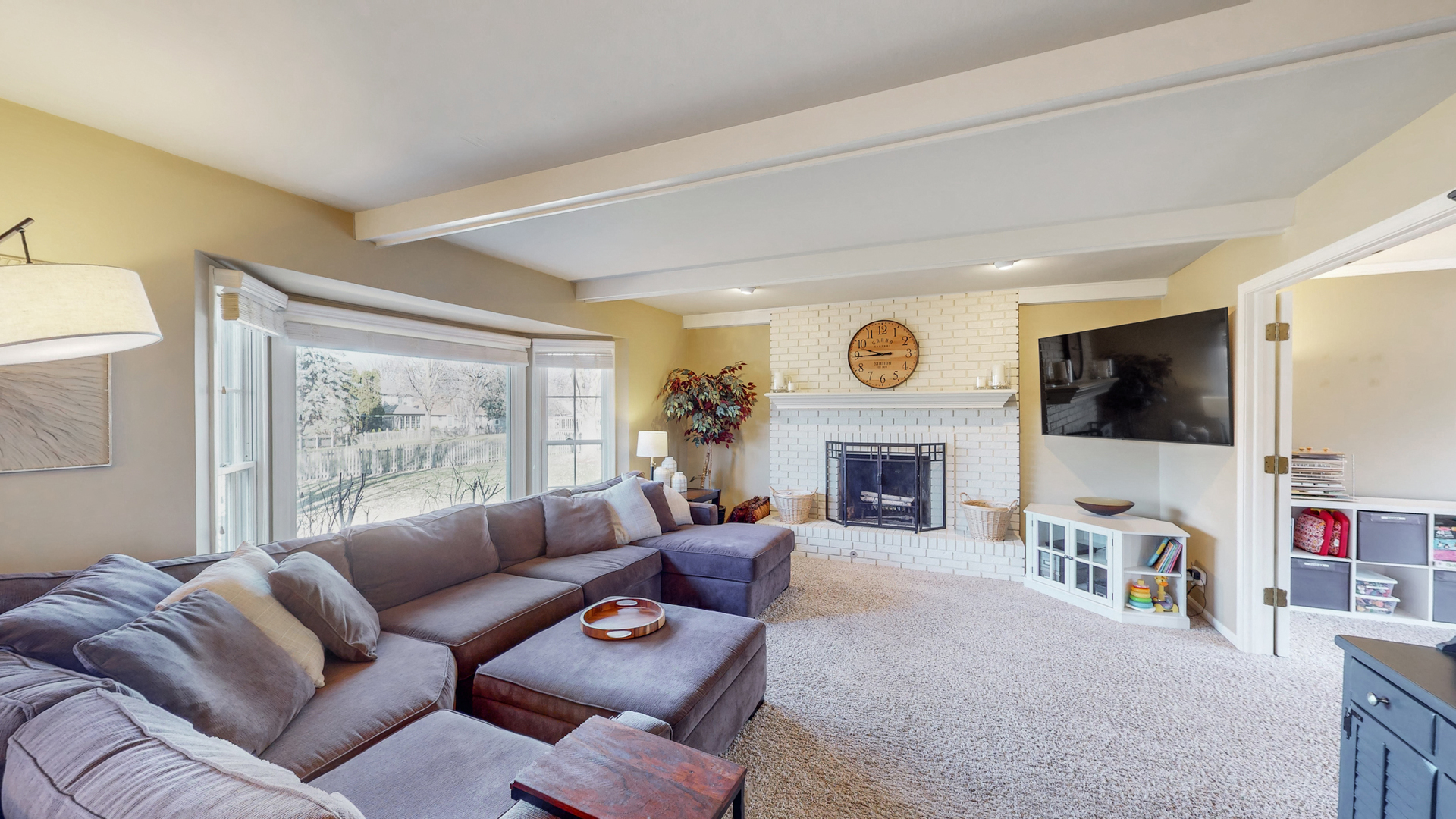 821 South River Road Naperville, IL 60540 - Photo 9 of 32 a living room with furniture a fireplace and a flat screen tv