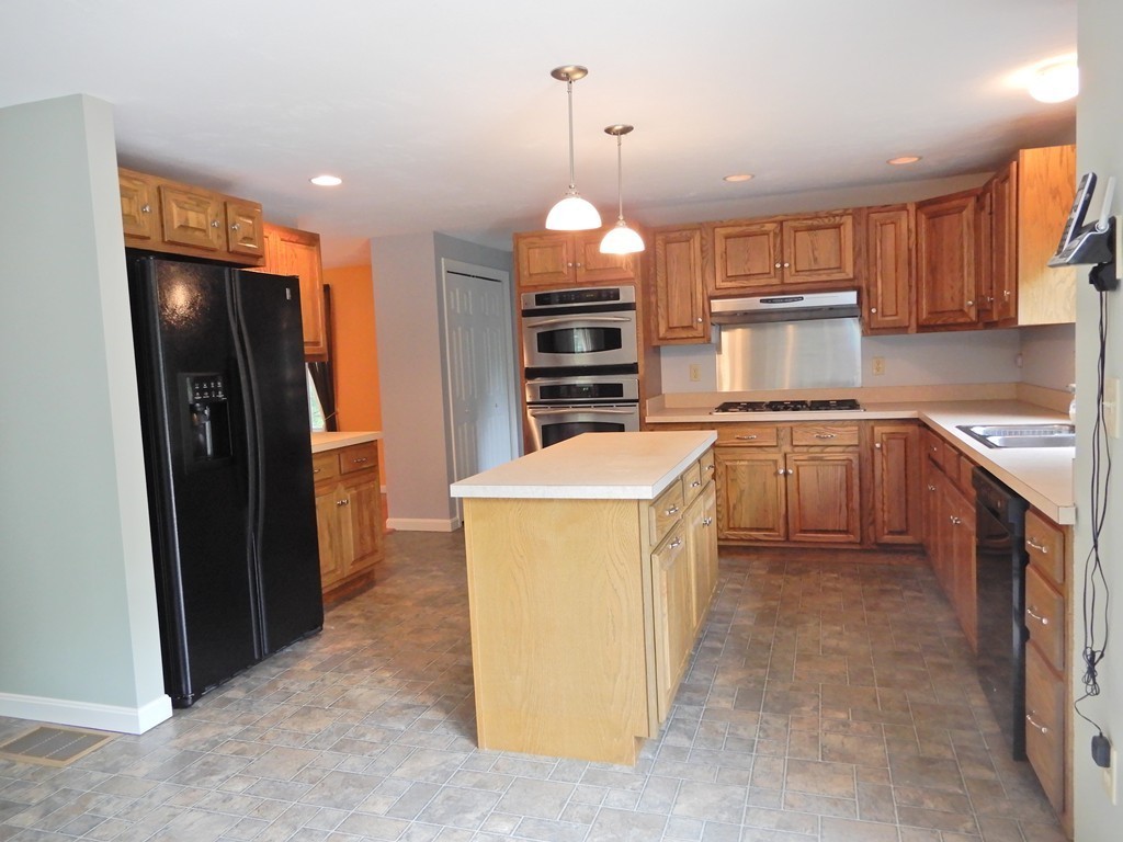82 Town Farm Road Brookfield, MA 01506 - Photo 8 of 28 a kitchen with kitchen island a counter top space a sink and stainless steel appliances