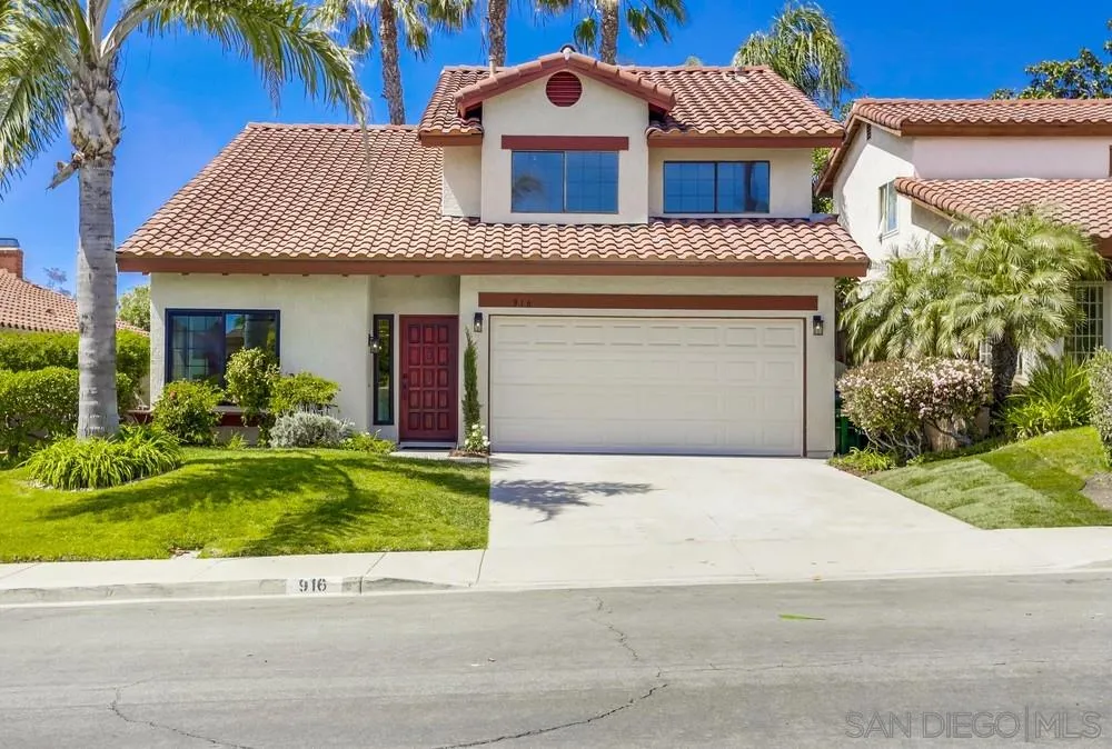 916 Alyssum Road Carlsbad, CA 92011 - Photo 1 of 42 a front view of a house with a garden and plants