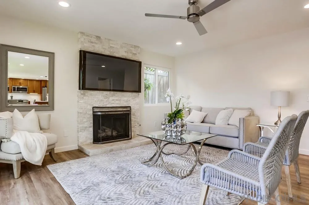 916 Alyssum Road Carlsbad, CA 92011 - Photo 11 of 42 a living room with furniture a fireplace and a flat screen tv