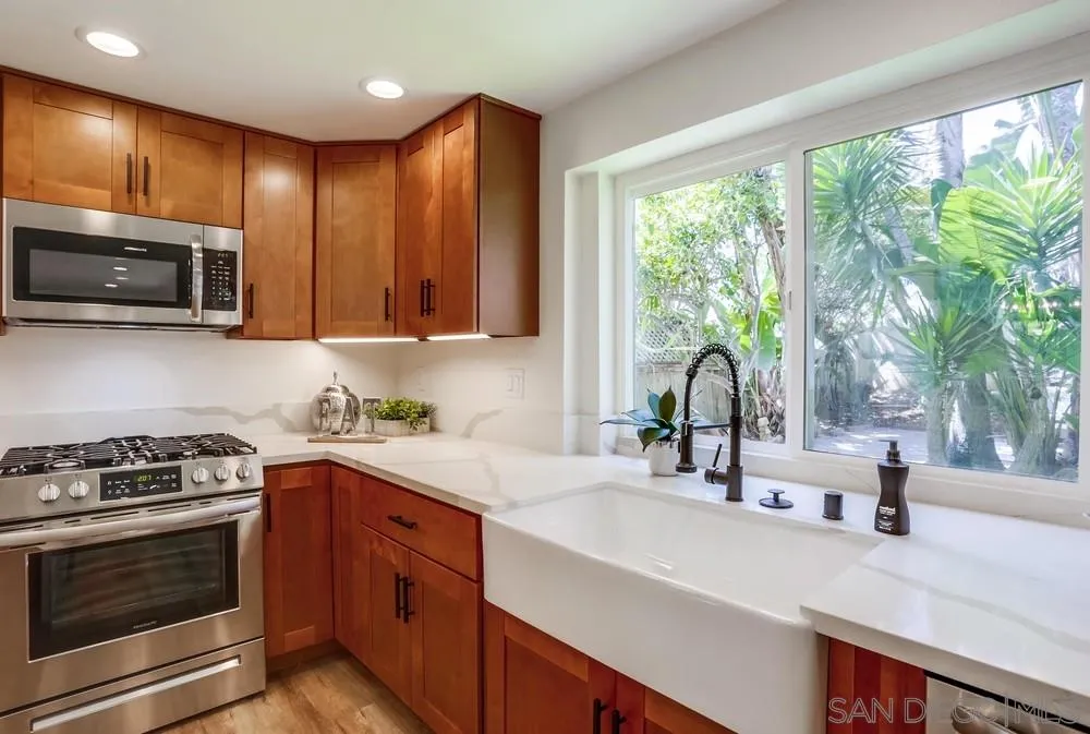 916 Alyssum Road Carlsbad, CA 92011 - Photo 18 of 42 a kitchen with a sink a stove and microwave