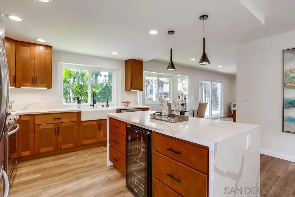 916 Alyssum Road Carlsbad, CA 92011 - Photo 19 of 42 a kitchen with stainless steel appliances granite countertop a sink a stove and a wooden floors