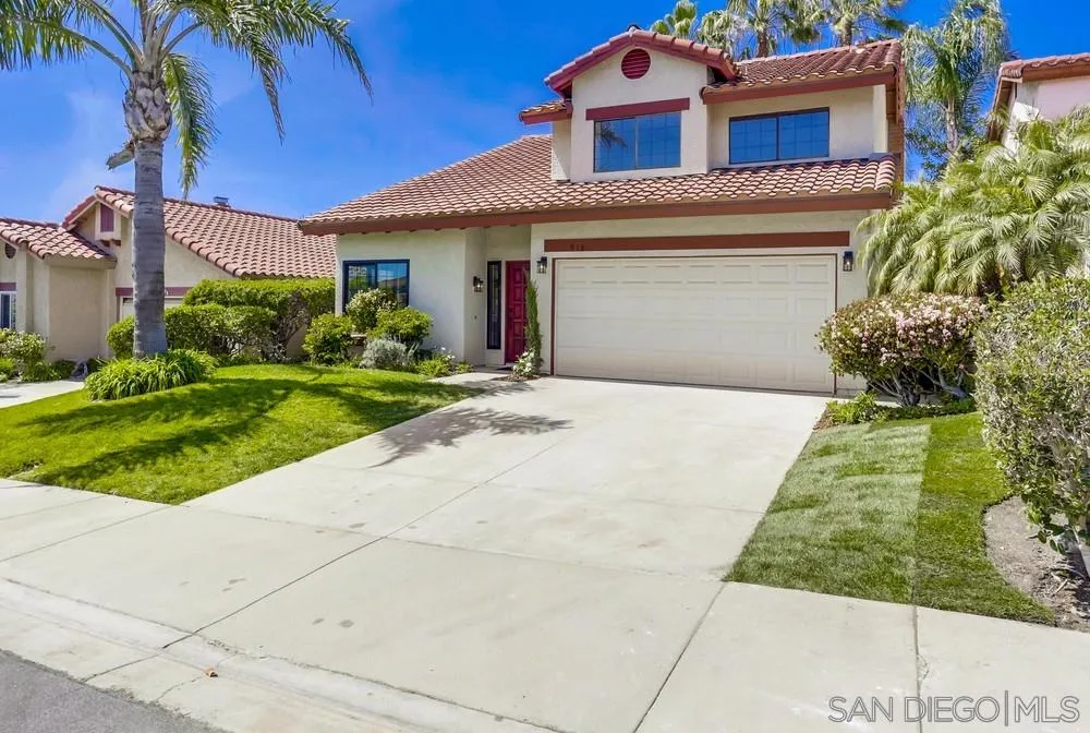 916 Alyssum Road Carlsbad, CA 92011 - Photo 2 of 42 a front view of a house with a yard and potted plants