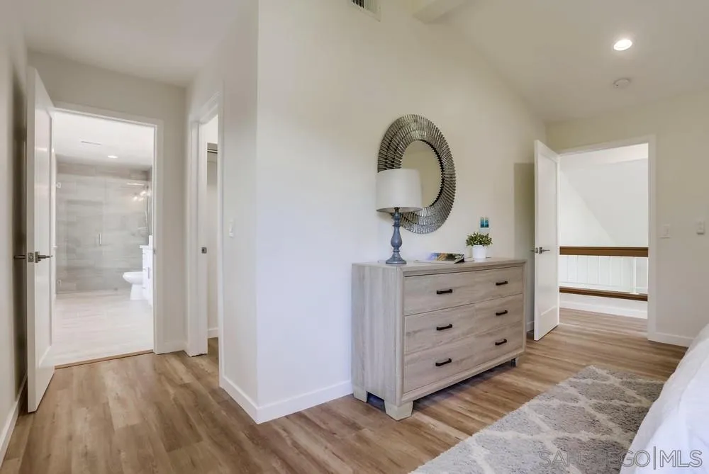 916 Alyssum Road Carlsbad, CA 92011 - Photo 24 of 42 a view of a dresser with mirror on the wall
