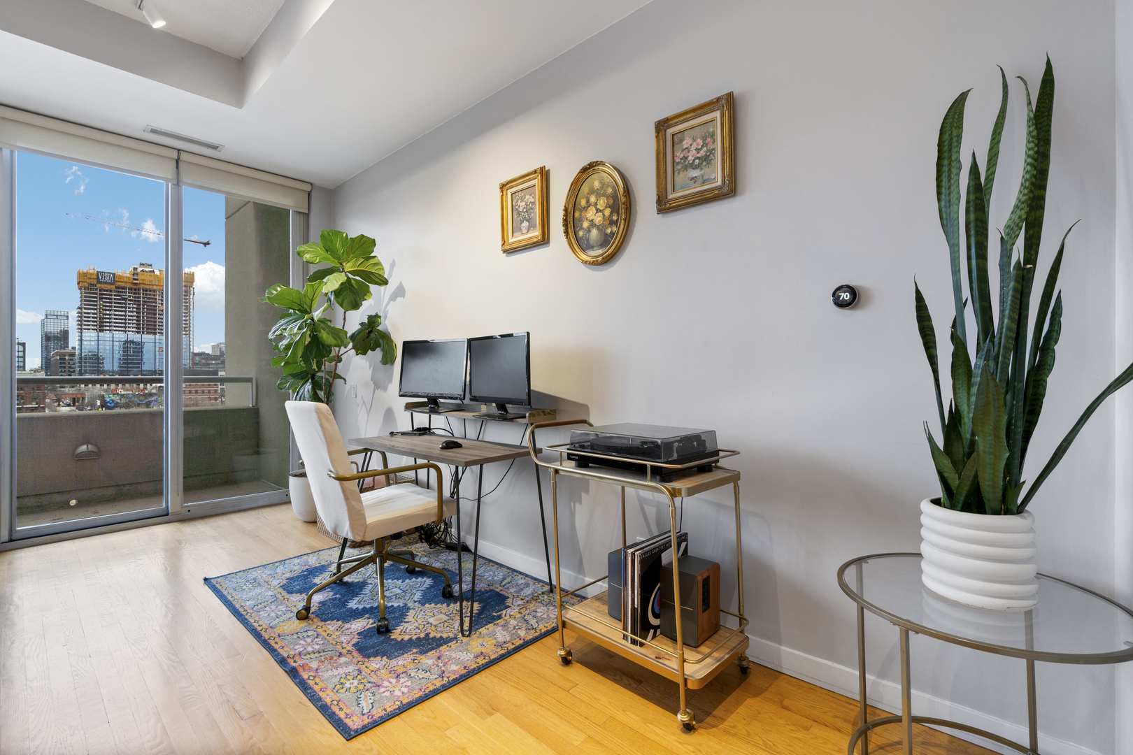 950 West Erie Street, Unit 602 Chicago, IL 60642 - Photo 12 of 18 a work room with furniture and a potted plant