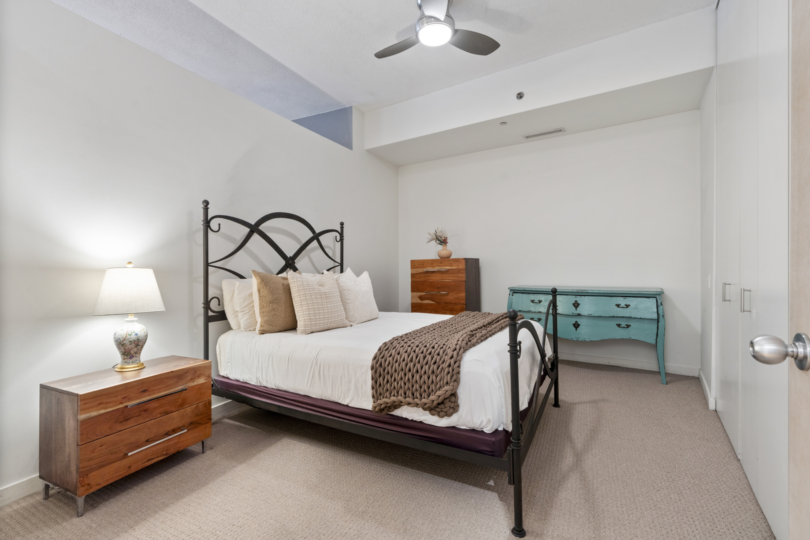 950 West Erie Street, Unit 602 Chicago, IL 60642 - Photo 13 of 18 a bedroom with a bed and a lamp on the dresser