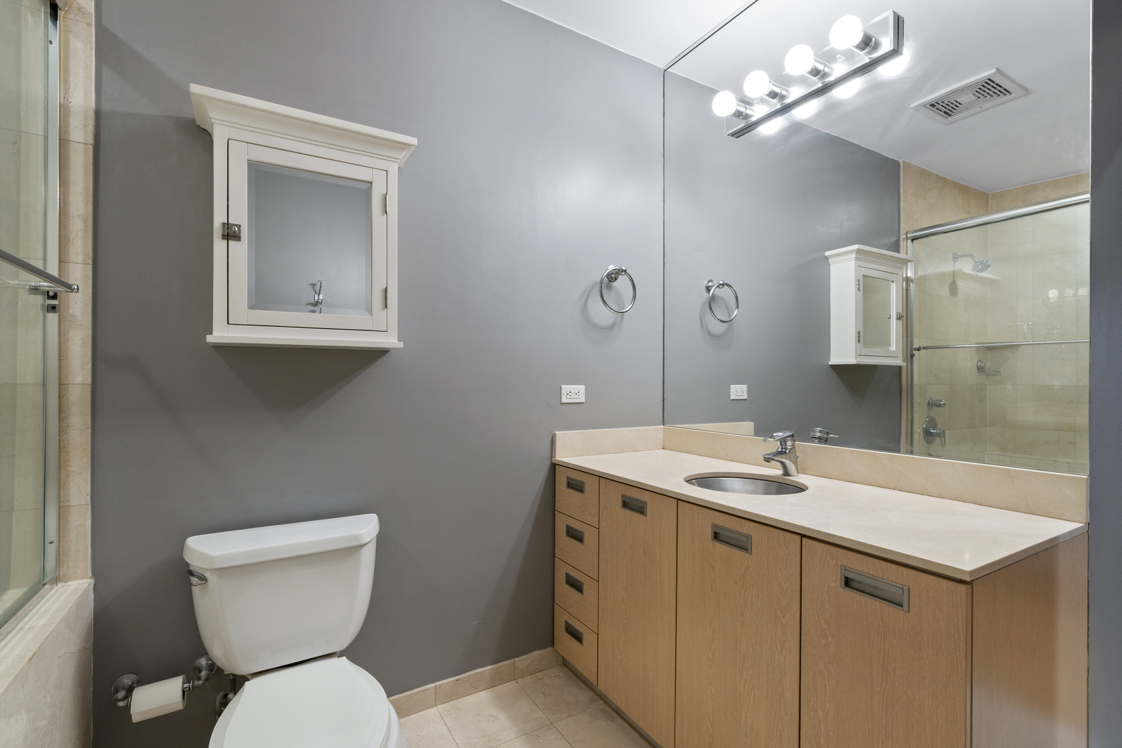 950 West Erie Street, Unit 602 Chicago, IL 60642 - Photo 14 of 18 a bathroom with a toilet sink and mirror