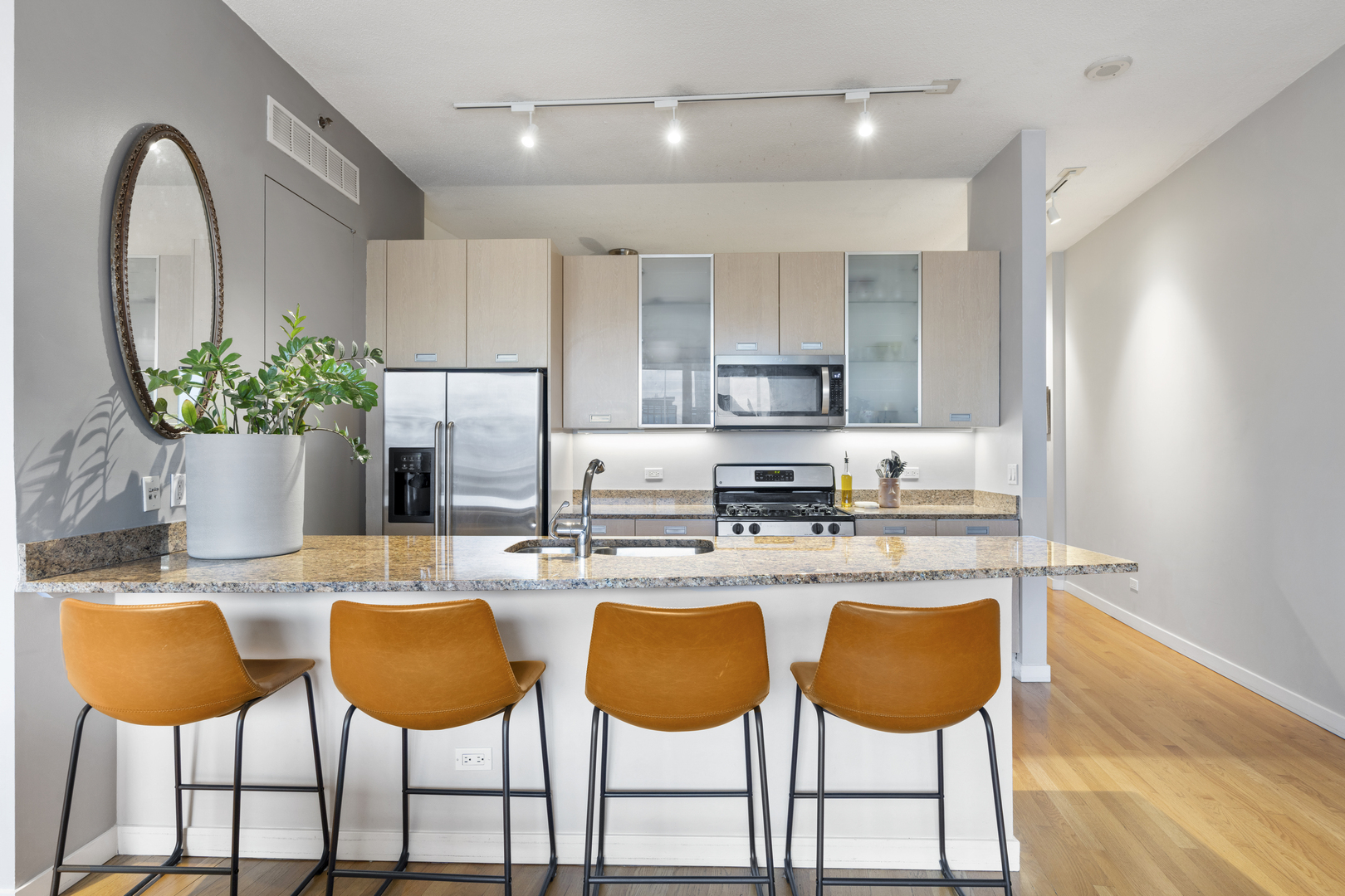 950 West Erie Street, Unit 602 Chicago, IL 60642 - Photo 4 of 18 a kitchen with stainless steel appliances granite countertop a dining table chairs and a refrigerator
