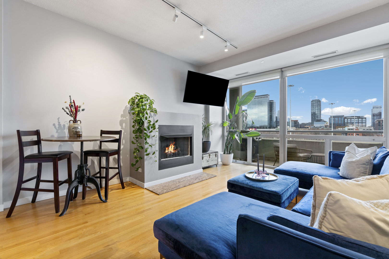 950 West Erie Street, Unit 602 Chicago, IL 60642 - Photo 7 of 18 a living room with furniture fireplace and a flat screen tv