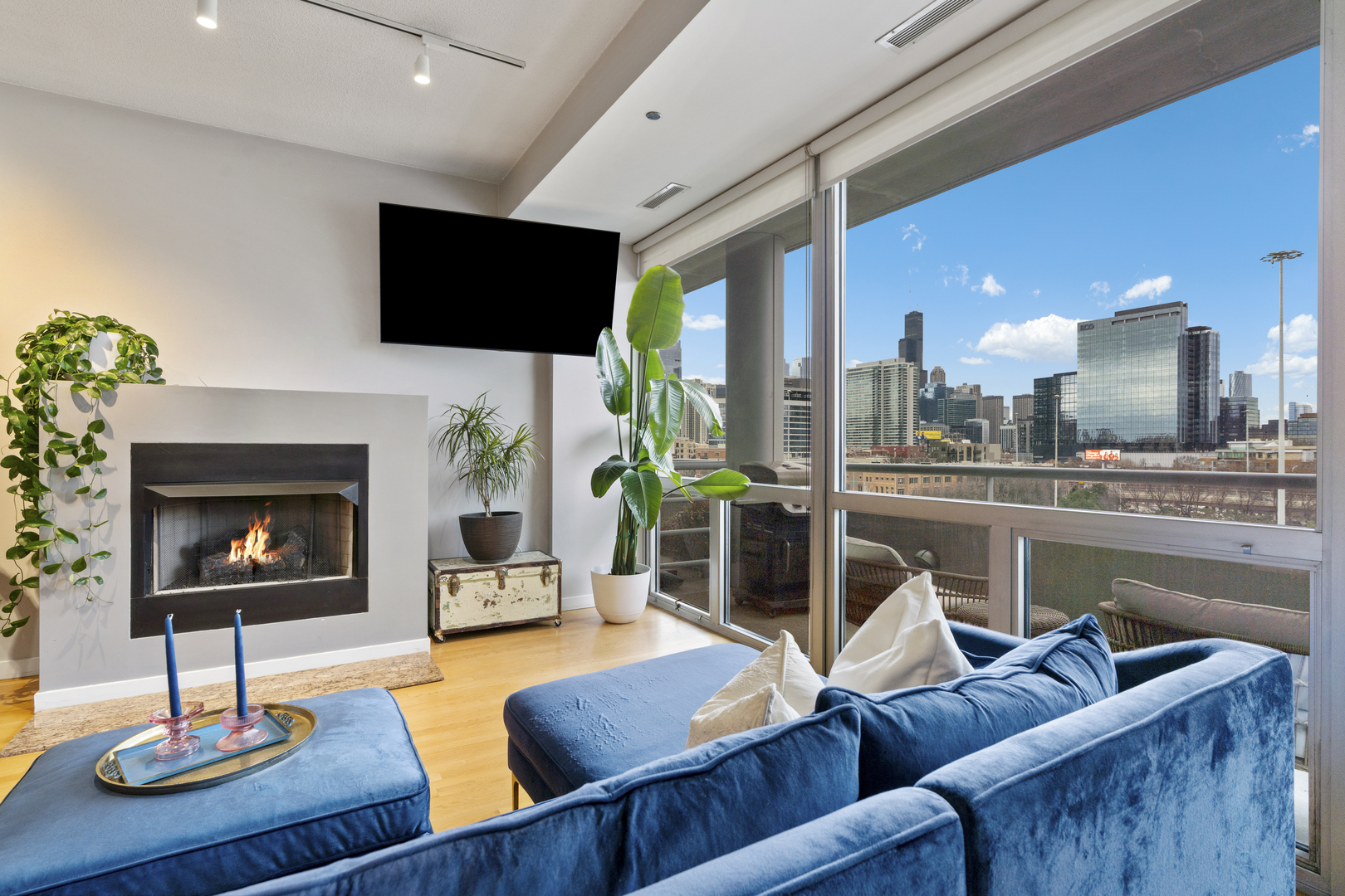 950 West Erie Street, Unit 602 Chicago, IL 60642 - Photo 10 of 18 a living room with furniture a flat screen tv and a fireplace