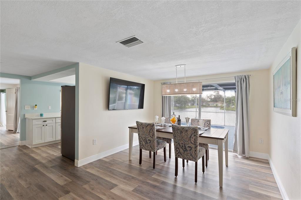 3409 Springfield Drive Holiday, FL 34691 - Photo 12 of 37 a view of a dining room with furniture and wooden floor