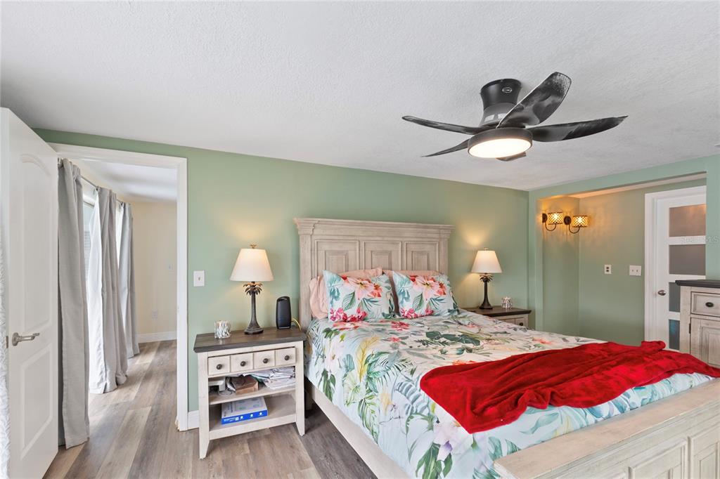 3409 Springfield Drive Holiday, FL 34691 - Photo 16 of 37 a bedroom with a large bed and a chandelier